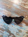 Black Nocturne Bats sunglasses by TORTURE COUTURE featuring bat-shaped frames and dark tinted lenses.