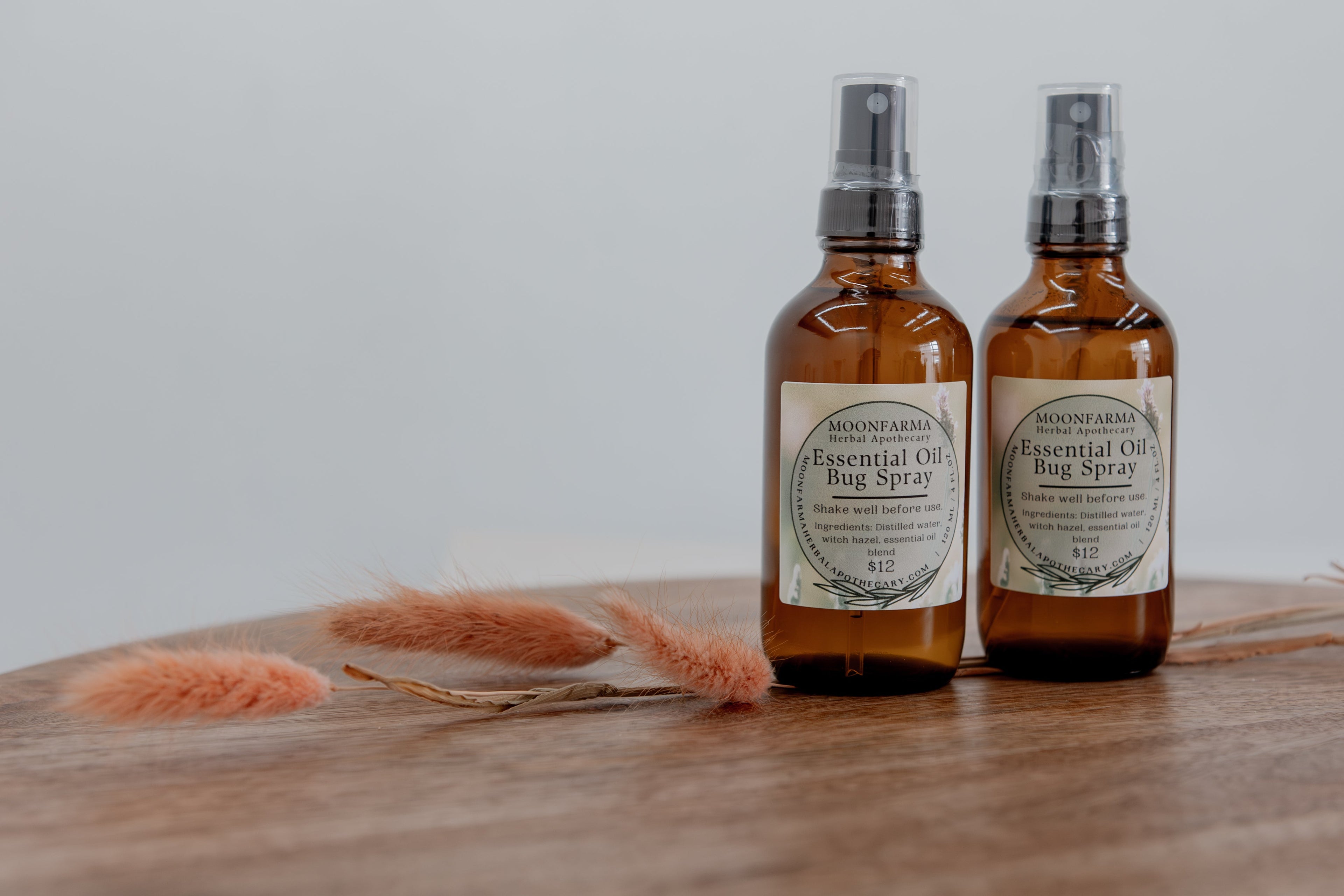 Bottle of MoonFarma essential oil bug spray with natural ingredients, designed to repel insects effectively.