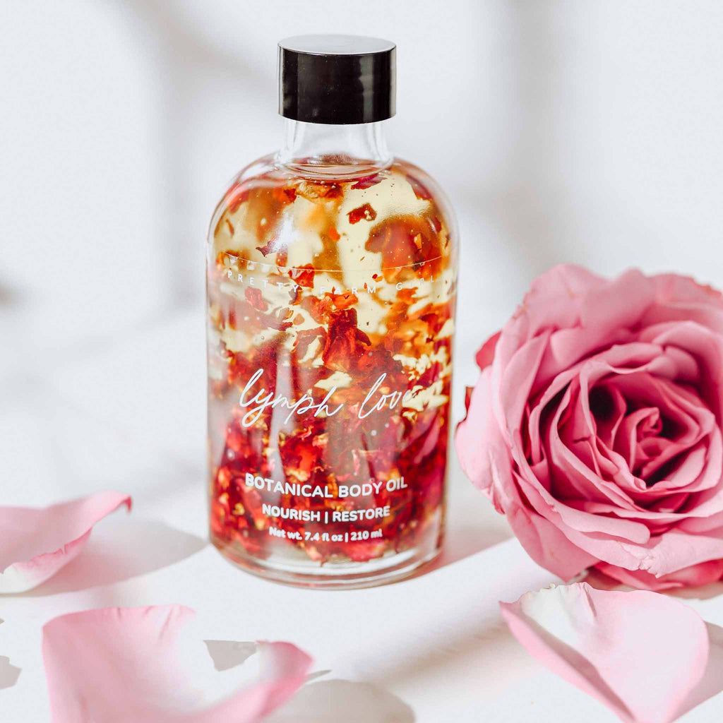 Pretty Farm Girl Lymph Love natural body oil for lymphatic massages, featuring a sleek bottle with a pump dispenser.