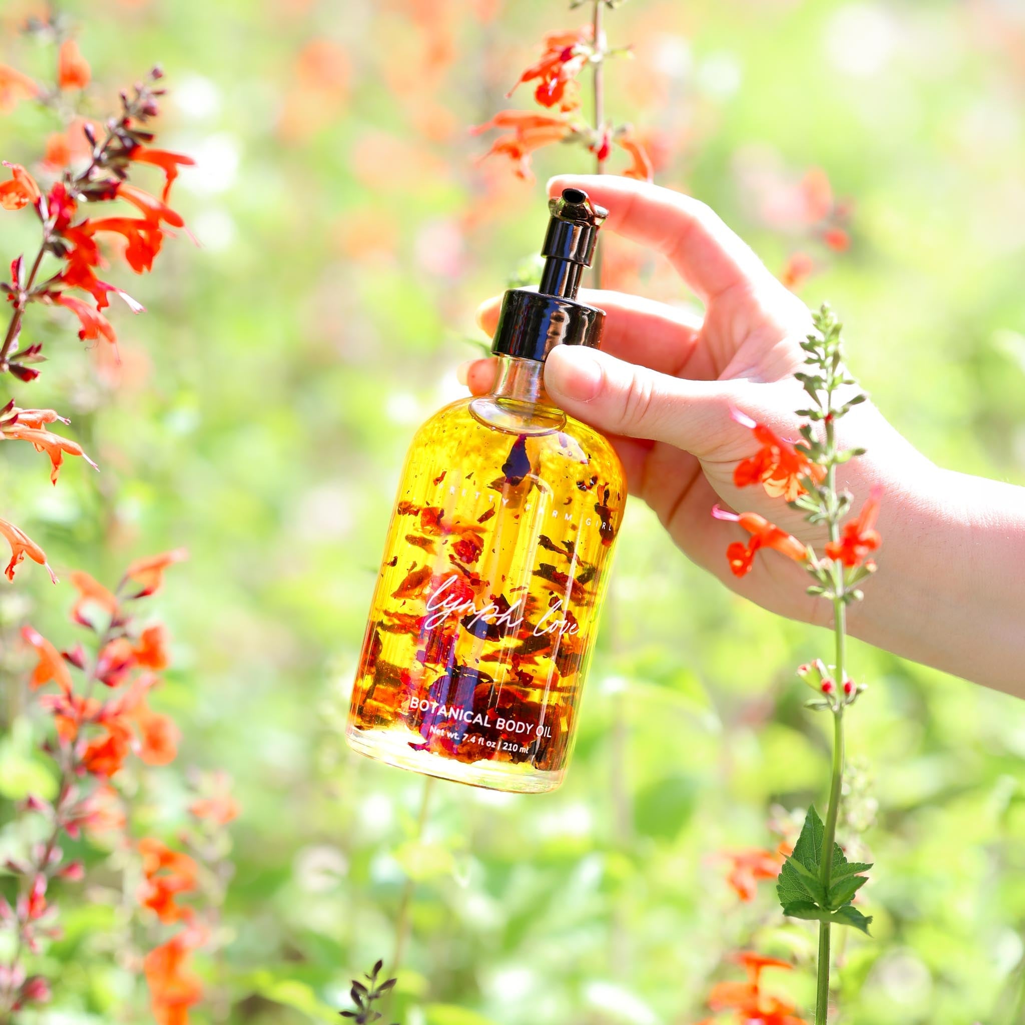 Natural body oil bottle labeled Lymph Love by Pretty Farm Girl, designed for lymphatic massages in health and beauty care.
