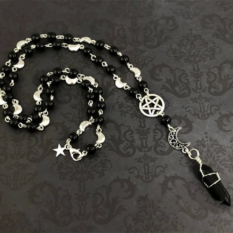 Black onyx bead necklace with pentacle and moon charms, featuring a mystical design from Green Witch Creations.