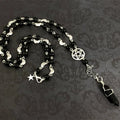 Black onyx bead necklace with pentacle and moon charms, featuring a mystical design from Green Witch Creations.
