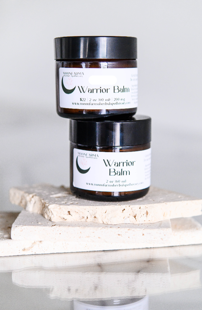 MoonFarma Warrior Balm for sore muscles, showing the herbal ointment jar with natural ingredients and soothing application.