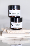 MoonFarma Warrior Balm for sore muscles, showing the herbal ointment jar with natural ingredients and soothing application.