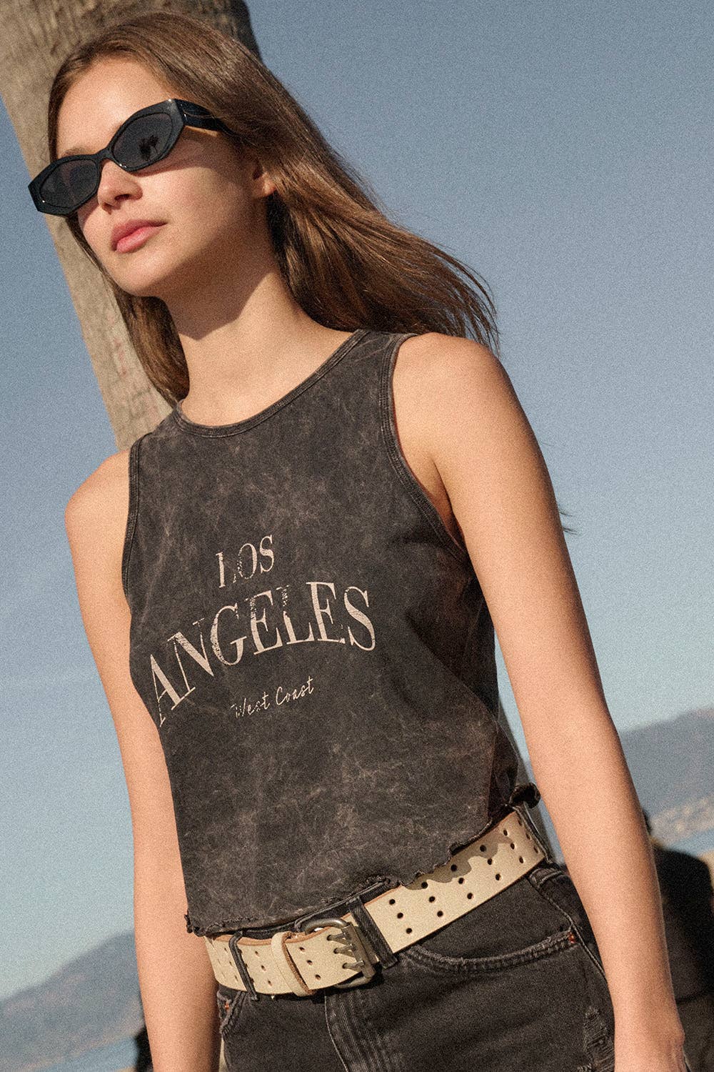 Rosie Karma Los Angeles Mineral Washed Graphic Tank Top featuring a relaxed fit and faded graphic design on soft fabric.