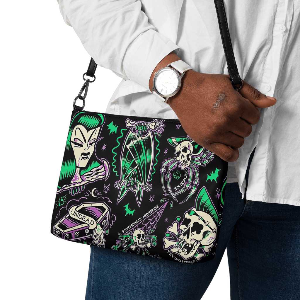 Black Psychobilly Blast crossbody bag by Goth Cloth Co. with bold graphic design and adjustable strap, stylish and functional accessory.