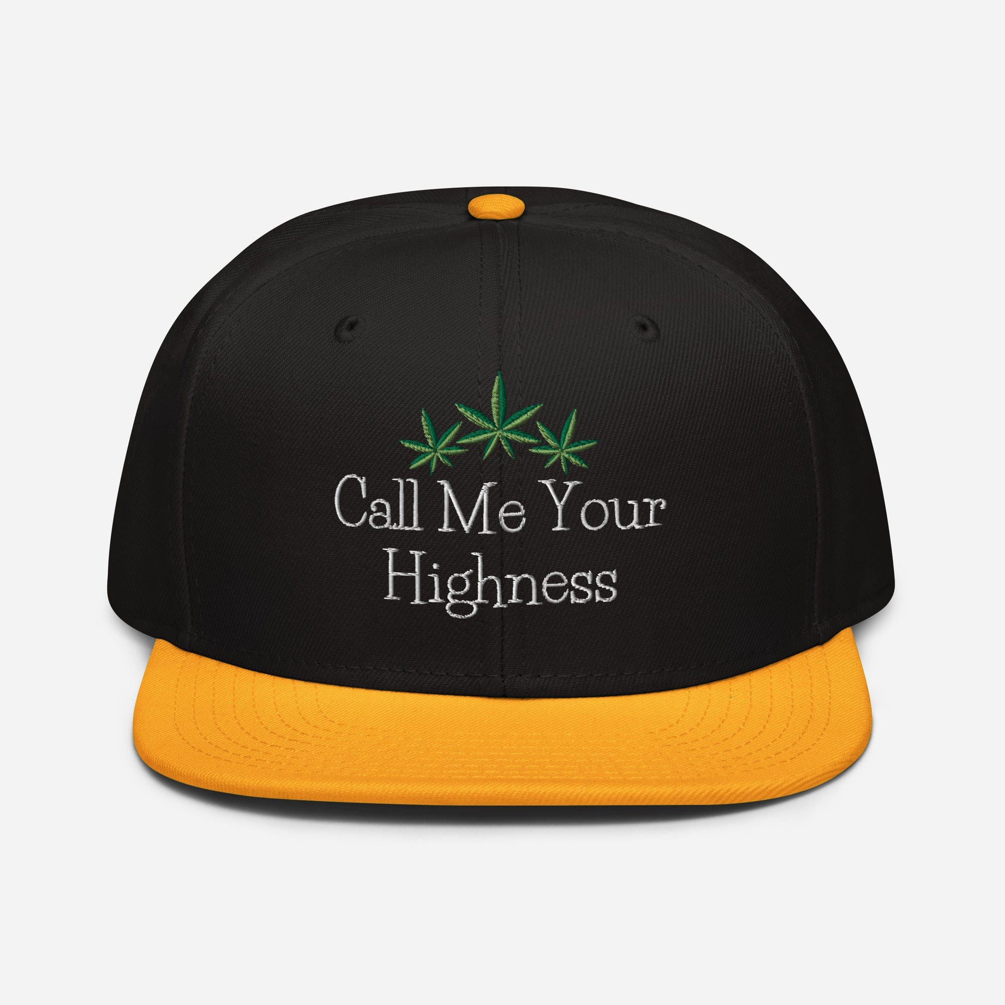 Black and gold Call Me Your Highness snapback hat by The Cannabis Community with a front design, adjustable strap, and flat brim