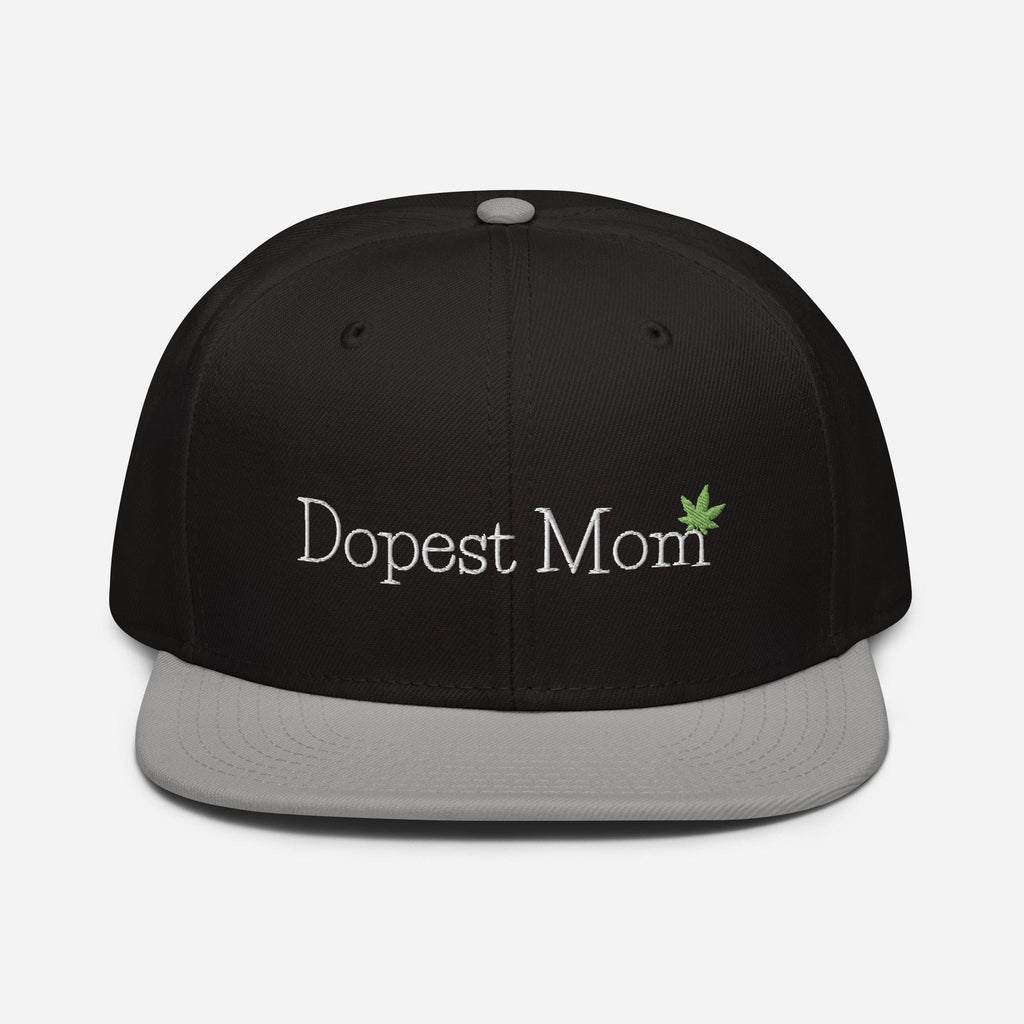 Gray and black Dopest Mom Cannabis Snapback hat by The Cannabis Community, featuring a classic front design and adjustable fit.